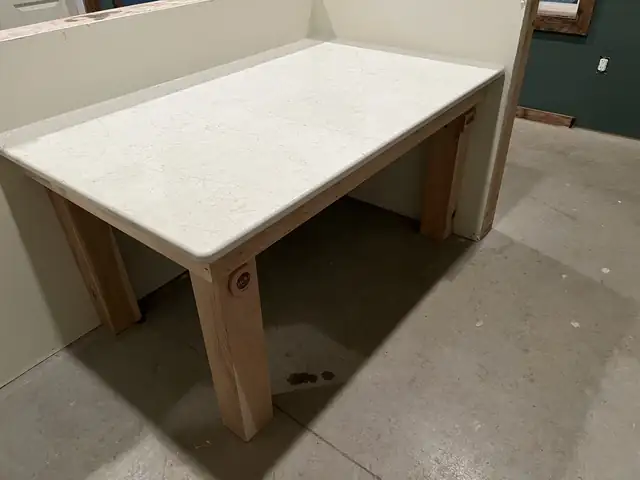 White quartz desk on wood legs built and installed by Completely Kitchens at Cultivating Hope Farms